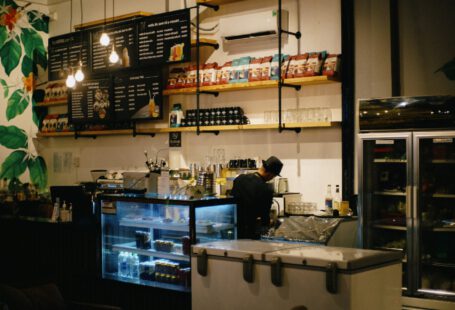 man in black shirt standing in front of counter