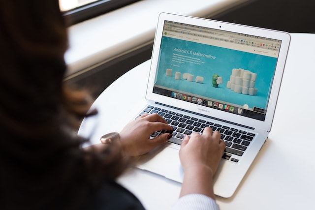 woman sitting beside table with laptop